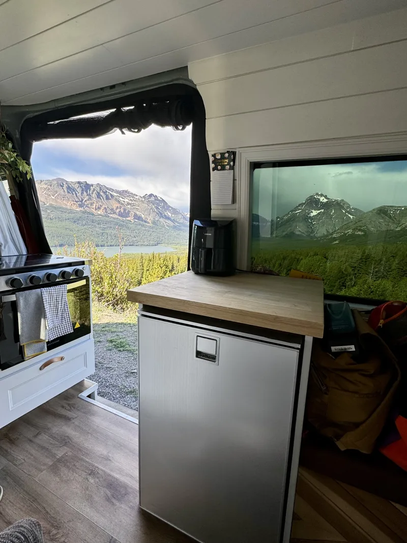 Refrigerator and window with mountains beyond