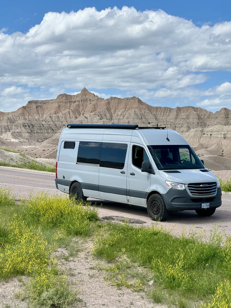 Pebbles parked against a rugged mountain backdrop