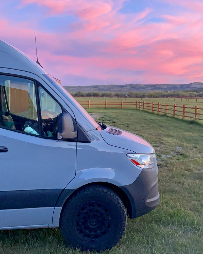 Purple sunset reflected above the front of the van