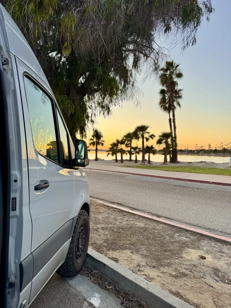 Palm trees at sunset outside the van in San Diego