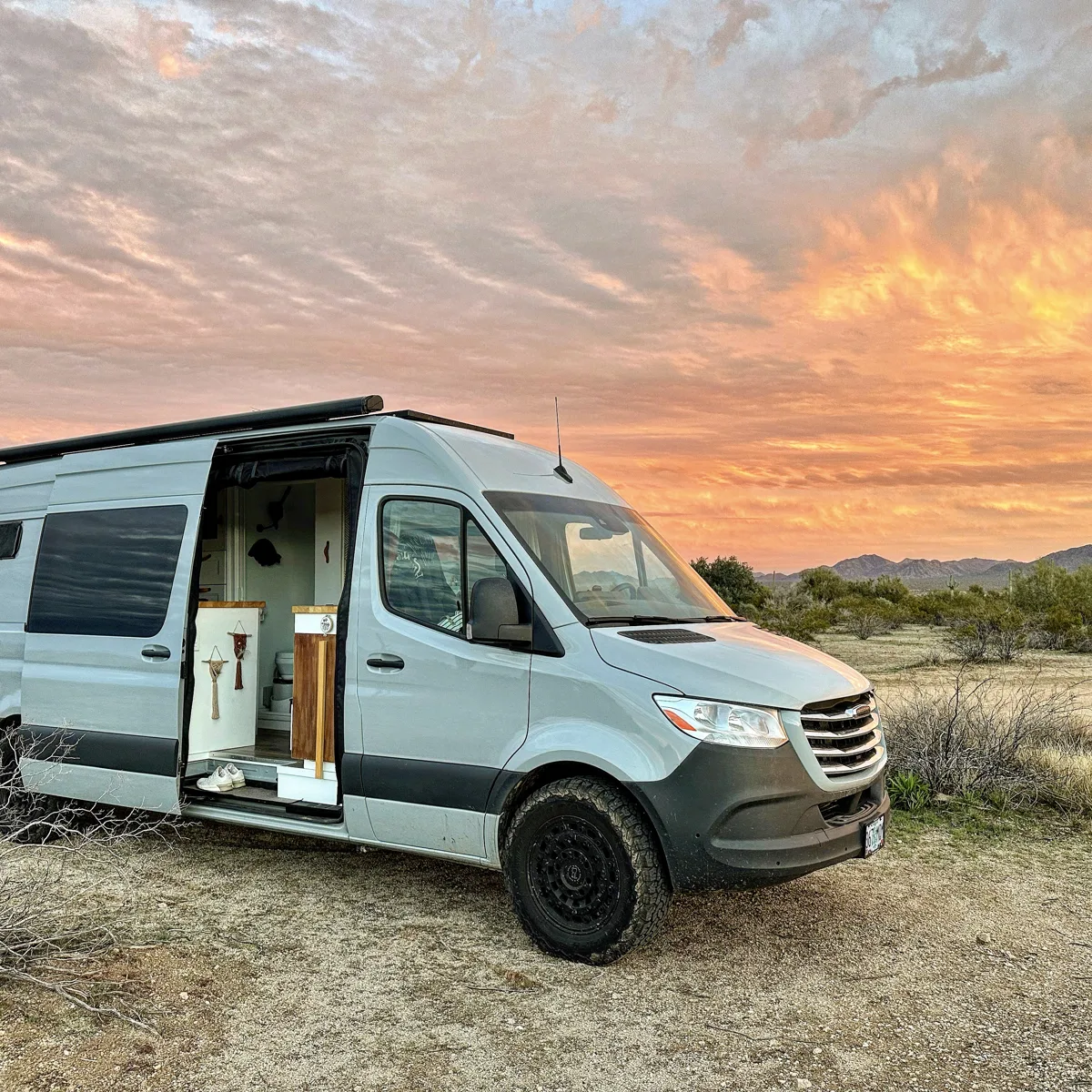 Pebbles with the sliding door open beneath a colorful sunset