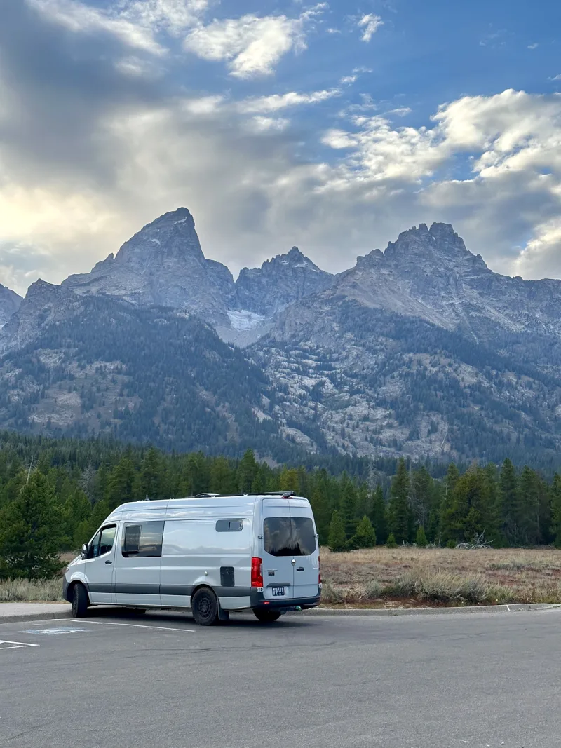 Pebbles parked beneath a dramatic mountain range