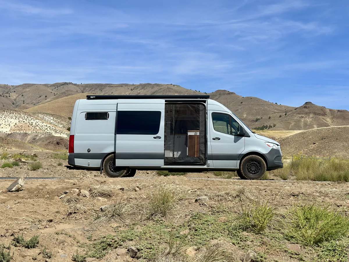 Side view of Pebbles parked in an open landscape