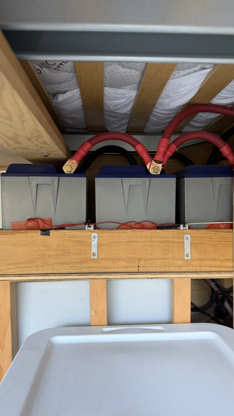 Battery bank and cables beneath the bed platform