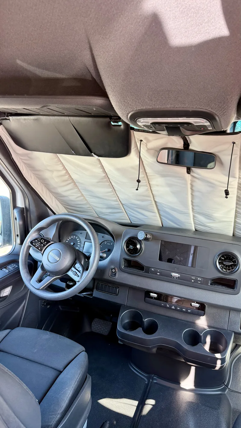 Insulated window covers fitted across the cab windshield