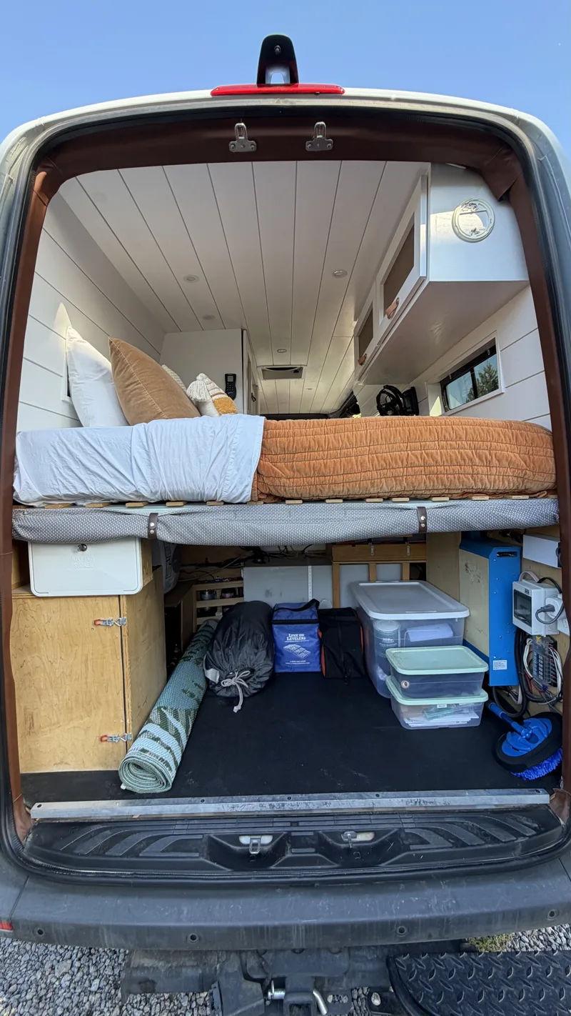 Rear doors open to show the bed and garage storage