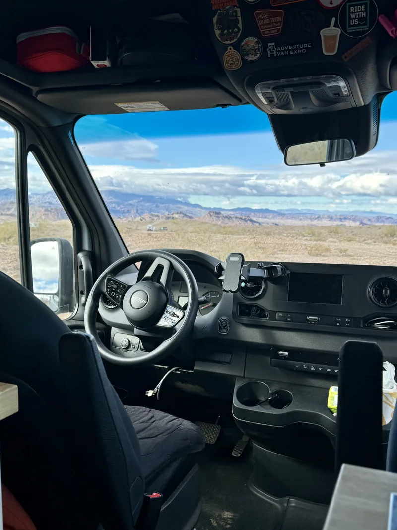 Steering wheel and dashboard with a view of open country