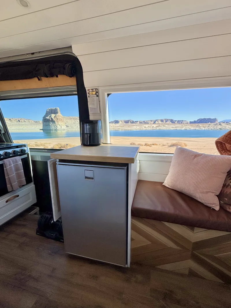 Fridge and bench seating beside a waterfront view