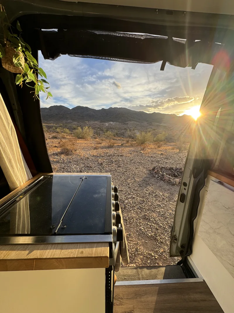 Sunset seen past the oven through the open van door