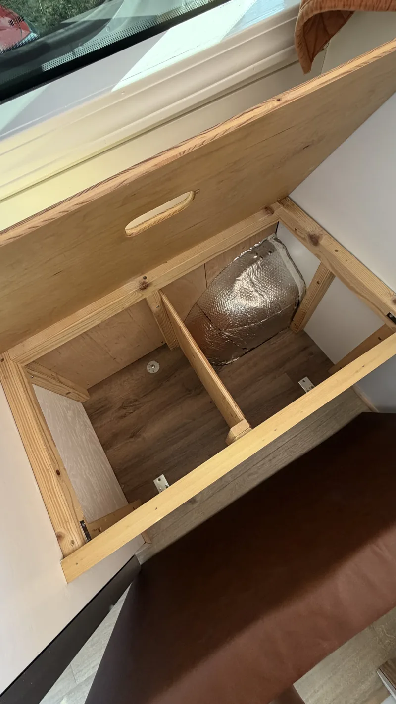 Bench seat lifted to reveal storage underneath