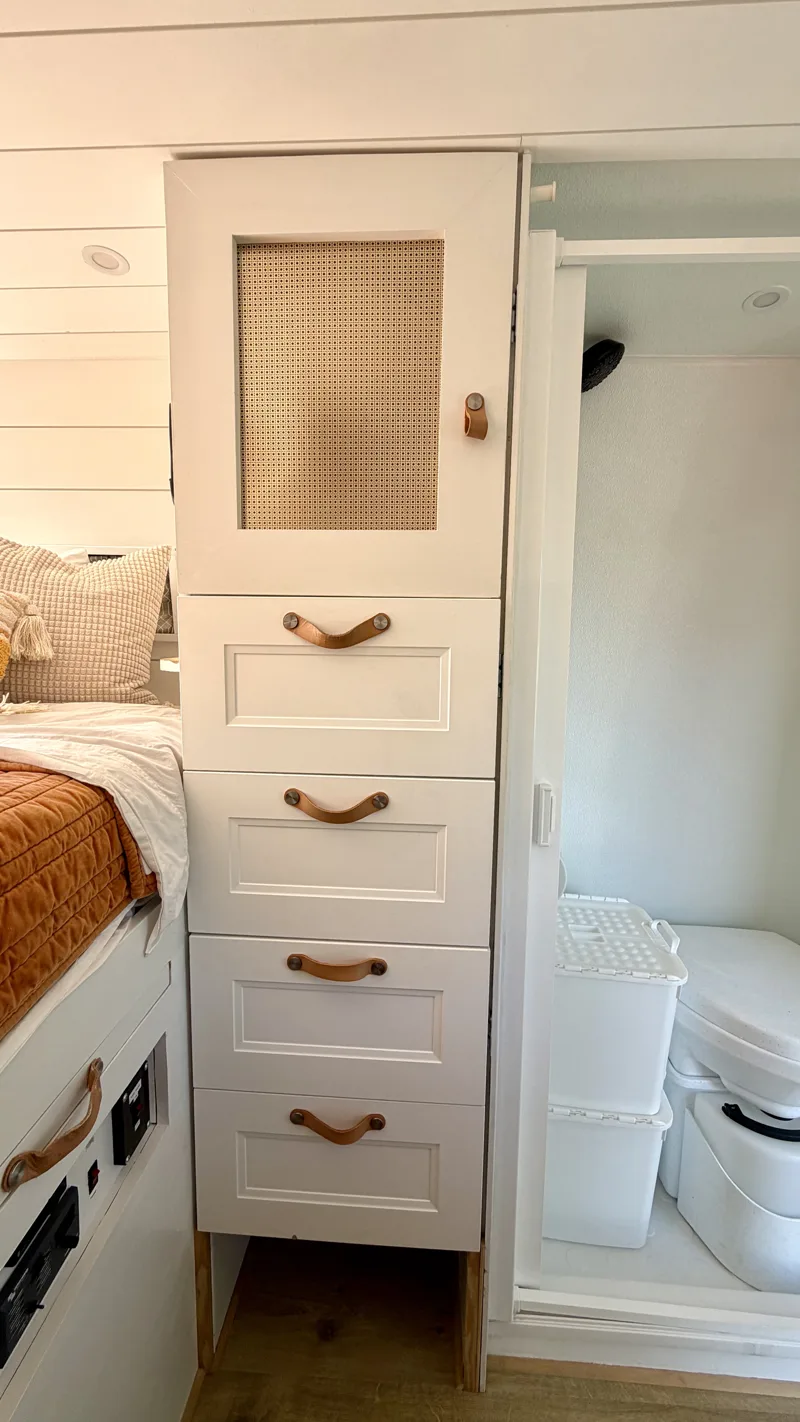 Clothing drawers and cabinet beside the bathroom