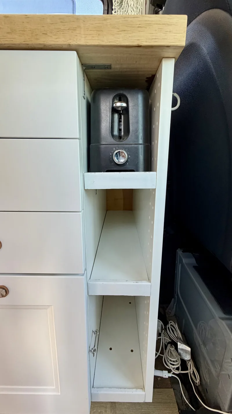 Narrow kitchen shelves beside the cab seat