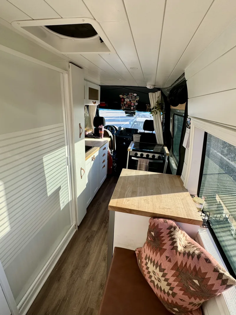 Interior showing dining table, bench, and bathroom
